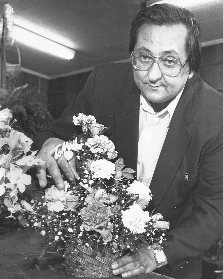 Perro's Flowers' founder, Anthony, poses with a Mother's Day bouquet